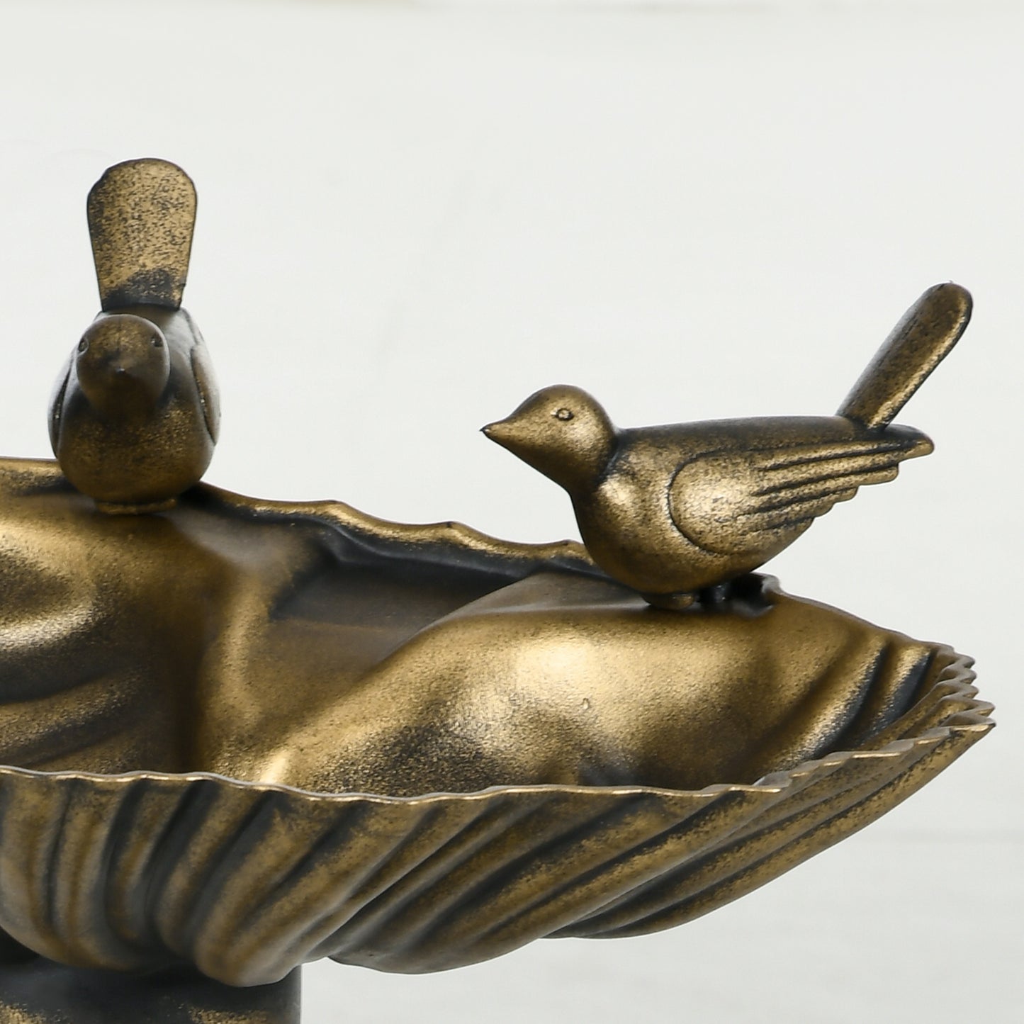 Detail of hand-painted bronze finish on decorative garden bird bath