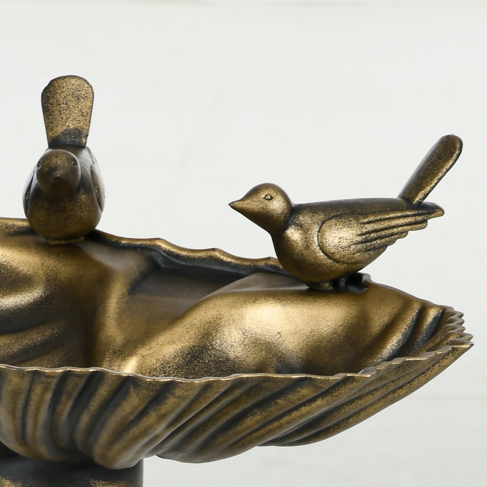 Detail of hand-painted bronze finish on decorative garden bird bath