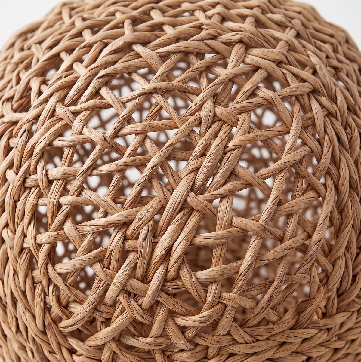 Close-up of the hand-braided water hyacinth weave texture on the cat bed, showing natural fiber craftsmanship