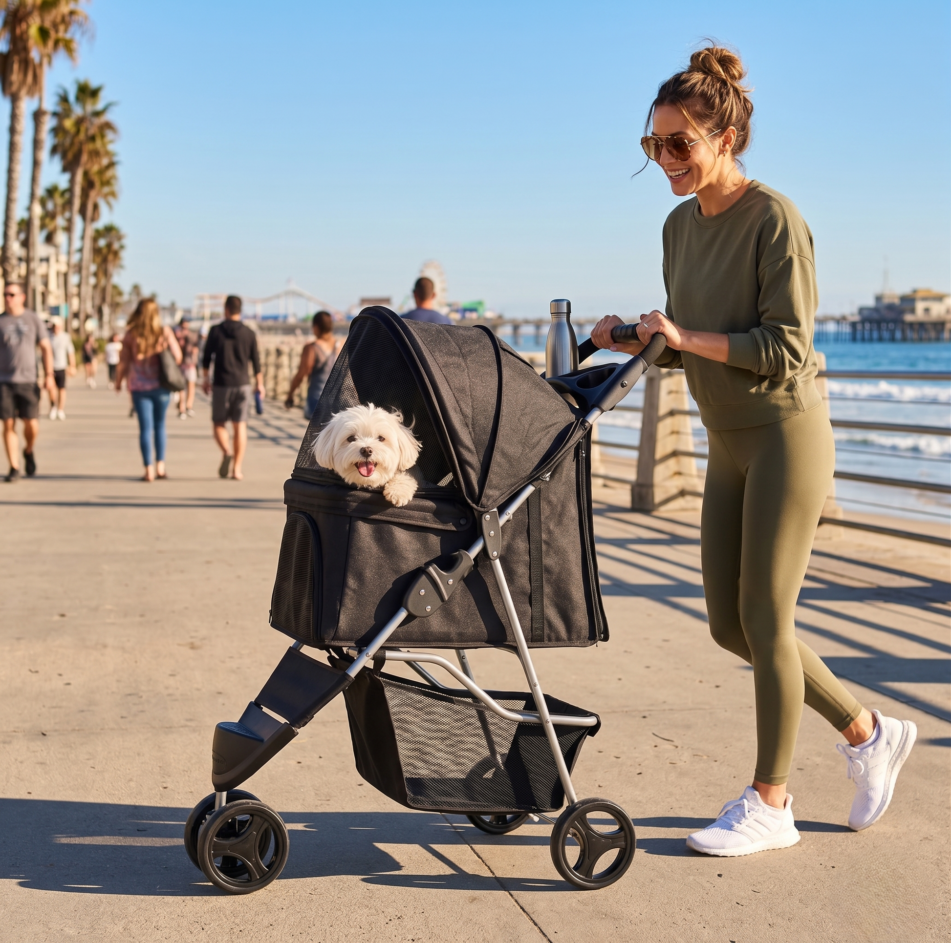 GianfiStore 3-Wheel Pet Stroller – woman in athleisure pushing black stroller with fluffy white dog on Santa Monica boardwalk, California